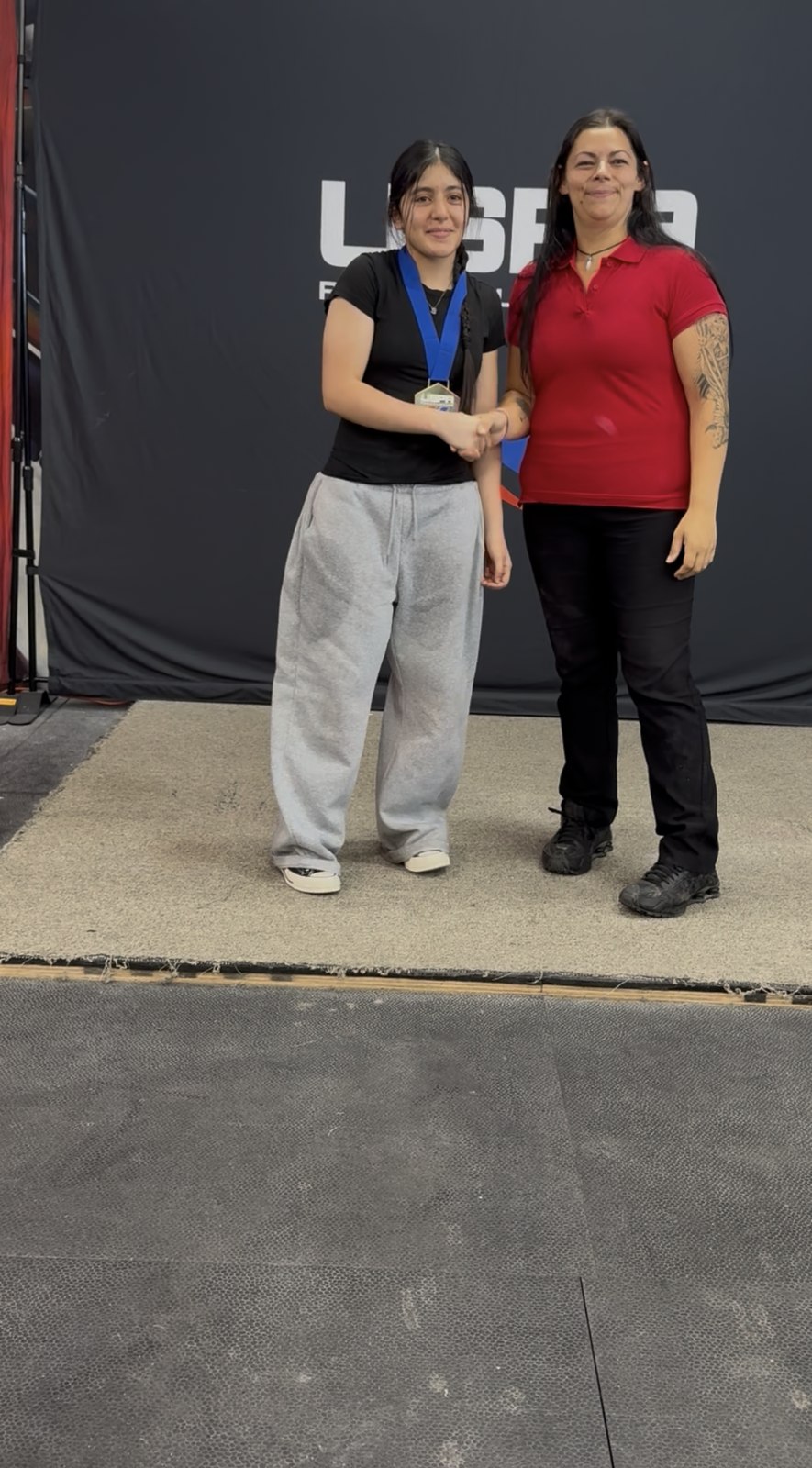 Fatima receiving recognition at the competition