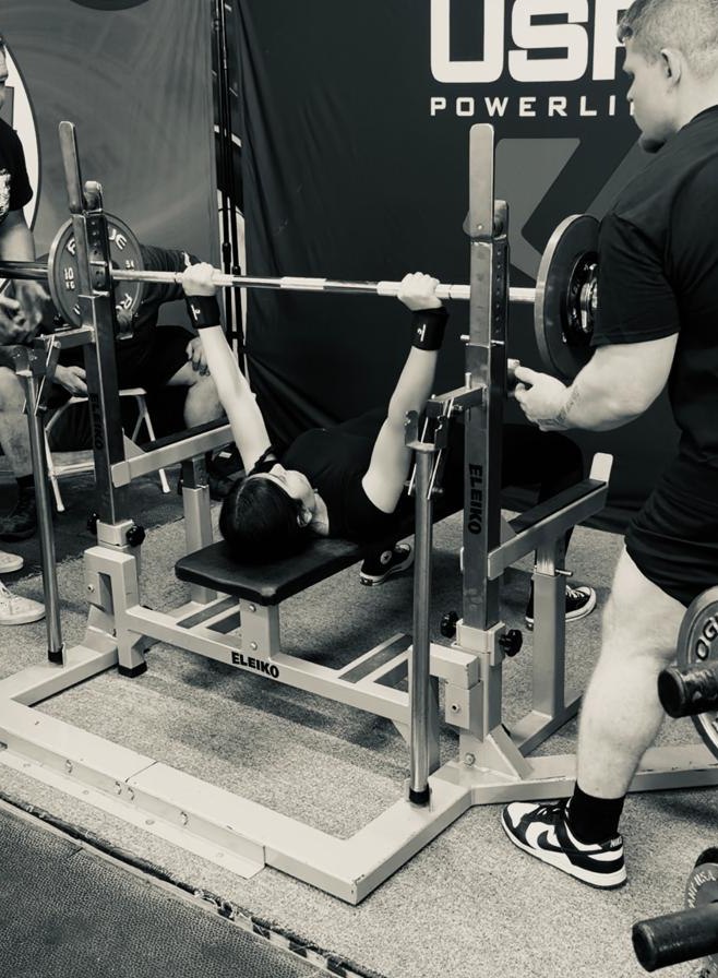 Fatima preparing for a lift on the platform
